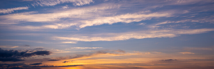 Picturesque evening sky with streaks of white cirrus clouds and sunlight. Sky replacement texture.