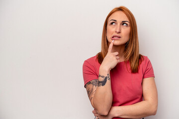 Young caucasian woman isolated on white background looking sideways with doubtful and skeptical expression.