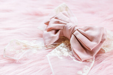 Fototapeta na wymiar Pink ribbon on a pink fabric with copyspace.