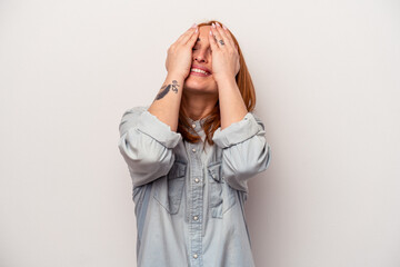 Young caucasian woman isolated on white background laughs joyfully keeping hands on head. Happiness concept.