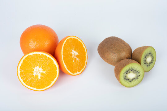 Flesh kiwi and apple cut ripe orange. Product of genetic engineering. 