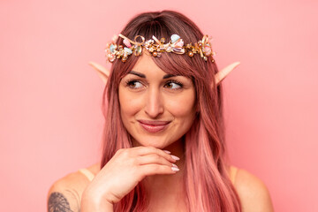 Fototapeta premium Young caucasian elf woman isolated on pink background