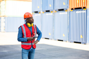 African American Industrial and factory Specialist. portrait of african american worker wearing protective hard hat helmet working at container yard.