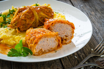 Wrapped minced meat in cabbage leaves and mashed potatoes - polish dish gołąbki

