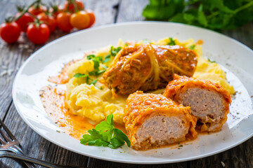 Wrapped minced meat in cabbage leaves and mashed potatoes - polish dish gołąbki
