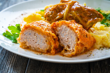 Wrapped minced meat in cabbage leaves and mashed potatoes - polish dish gołąbki
