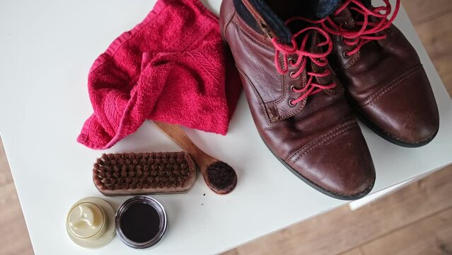 Dirty Worn Out Brown Leather Winter Boots Prepared for Waxing Waterproofing and Polishing With Shoe Care Accessories