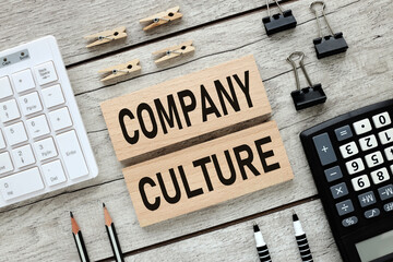 Company Culture text on two wooden blocks on a wooden table.
