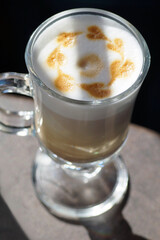 Top view of a coffee latte in the shape of small hearts on a sunny day