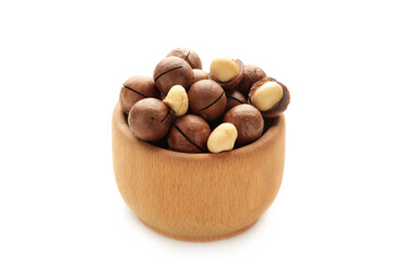 Peeled macadamia nuts on bowl. Horizontal composition isolated on white background.