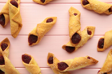 Tasty bagels with strawberry jam on pink wooden background. Homemade cookies