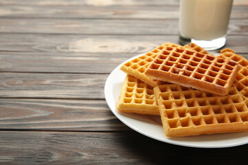 Belgian waffles on grey background. Belgian waffles with milk. Freshly baked Belgian waffles.