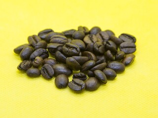 Coffee beans on the yellow background