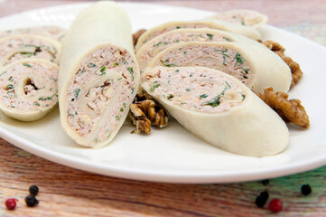Cheese roll with cottage cheese, nuts and fresh herbs