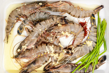 Large raw uncooked prawns or langoustines in shell.
