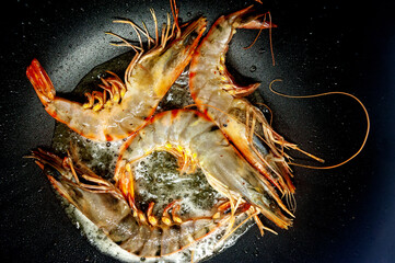 Large raw uncooked prawns or langoustines in shell.