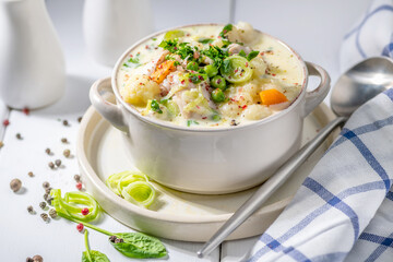 Thick creamy chicken soup with vegetables.