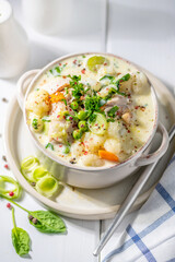 Thick creamy chicken soup with vegetables.