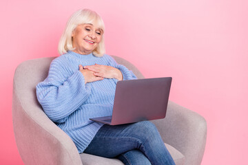 Portrait of attractive cheerful grey-haired woman calling video web cam talking isolated over pink pastel color background