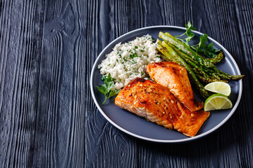 fried salmon fish fillet with rice and asparagus