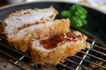 The pork cutlet sprinkled with sauce looks delicious.