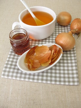 A cup of onion peel tea with honey
