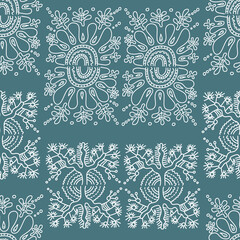 Seamless pattern with abstract ethnic motifs. White pattern in doodle style on a dark emerald background. Vector illustration.

