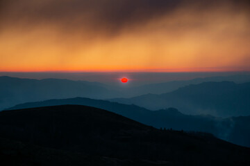 Sunset, with impressive red sunset color in the north of Portugal, caused by smoke from authorized burning in February 2022