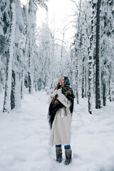 Fototapeta na wymiar Russian beautiful girl in winter forest