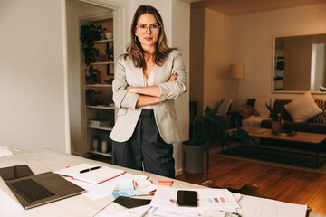 Confident interior designer standing in her home office - obrazy, fototapety, plakaty