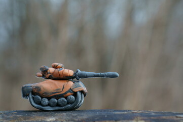 A toy tank made of plasticine with a close-up tower.