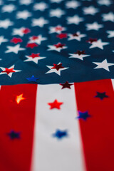 Colored shiny stars on American Flag Background. Expression of Patriotism and Love for their Country, the United States. Independence Day is July 4. Memorial Day. Vertical photo.