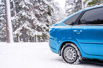 Blue car in winter snow forest