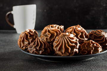 Dark marshmallows in chocolate on a dark background, homemade dessert, side view
