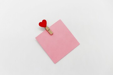 Sticky note with a heart on a clothespin