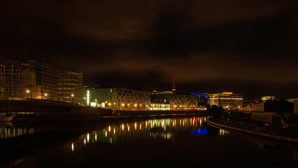 View over the Spree to office buildings in Berlin at night.