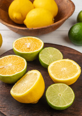 Orange, green lemon and sicilian lemon cuts over wooden board