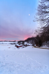 Photograph of a farm during a winter sunrise