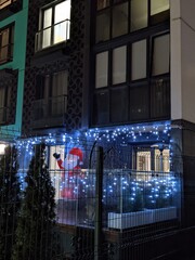 Christmas decorations and vibe of holiday on one balcony in the city