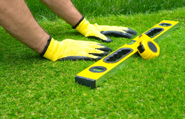 Worker doing the artificial grass installation.