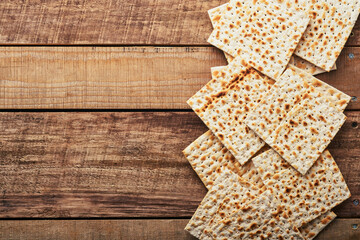 Matzah. Traditional ritual Jewish bread on old wooden rustic background. Passover food. Pesach Jewish holiday of Passover celebration concept.