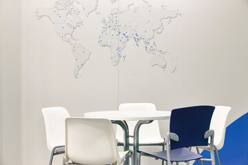 Workplace room with table, chairs and world map