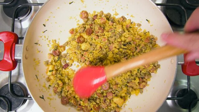 Northeastern Feijao Tropeiro, brazilian dish made with cuscuz, string bean, sausage, bacon, chive and curd cheese. Zoom in effect.