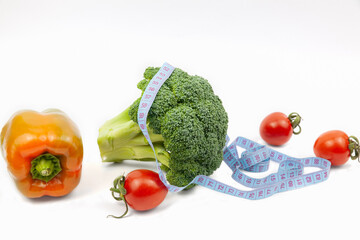 Fresh broccoli, pepper and tomatoes on white background