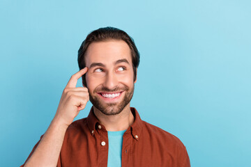 Photo of optimistic beard young guy look promo wear brown shirt isolated on blue color background