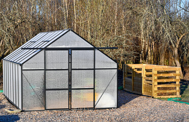 big greenhouse covered in frost and compost