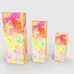 Drei unterschiedlich große Parfümverpackungen mit einem bunten floralen Muster.