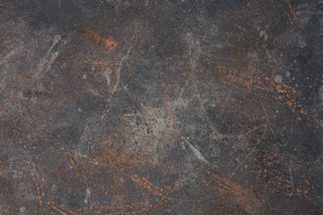 Dark gray and brown background with stains of copper, bronze and cast iron paint. 