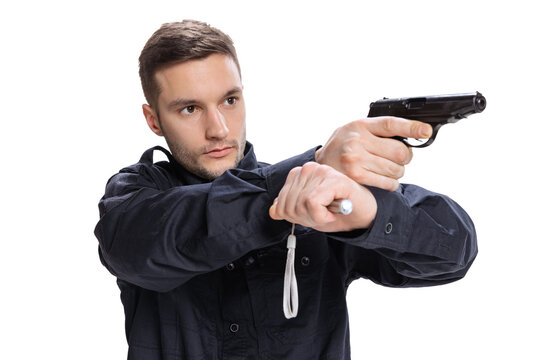 Studio shot of young man, policeman officer wearing black uniform with gun isolated on white background. Concept of job, caree, law and order.