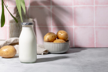 Bottle of potato milk on the table. Plant-Based Potato Milk Alternative, Vegan Milk